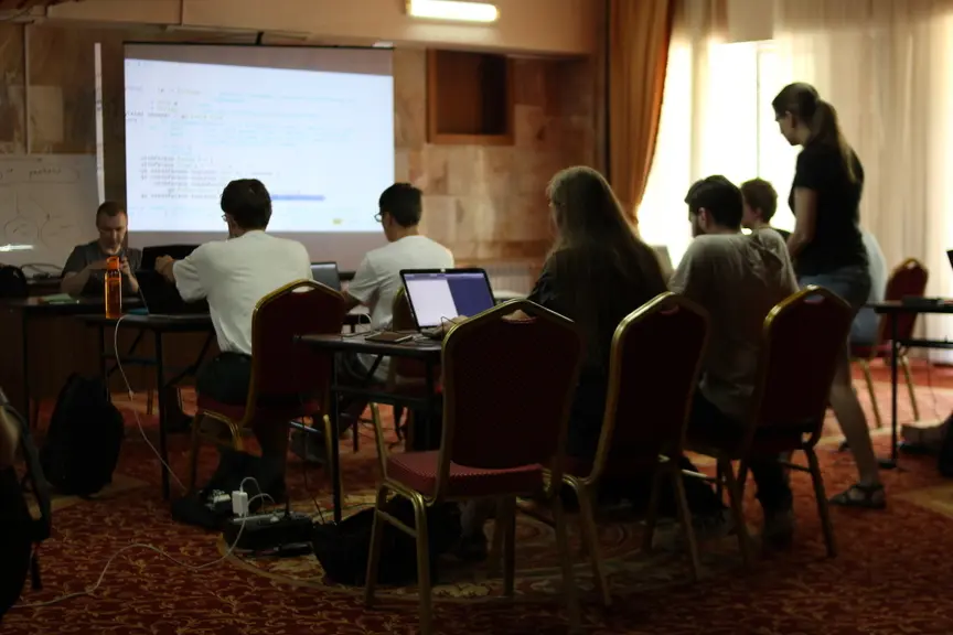 A group of students listening to a lecture on Haskell
